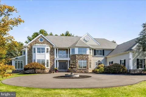 a view of a house with a big yard and large trees