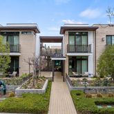 a front view of a house with yard and green space
