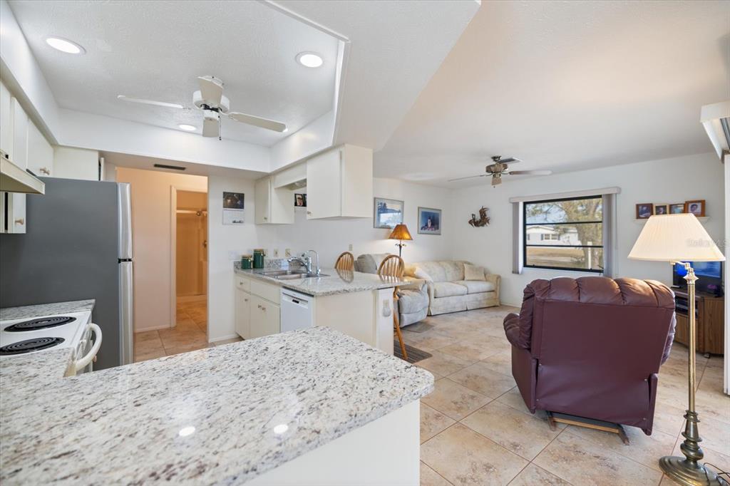 420 Duke Road Venice, FL 34293 - Photo 12 of 31 a living room with furniture a chandelier fan and a window