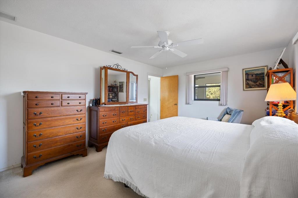 420 Duke Road Venice, FL 34293 - Photo 19 of 31 a bedroom with a bed and wooden floor