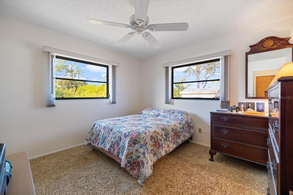 420 Duke Road Venice, FL 34293 - Photo 21 of 31 a bedroom with a bed and a chandelier