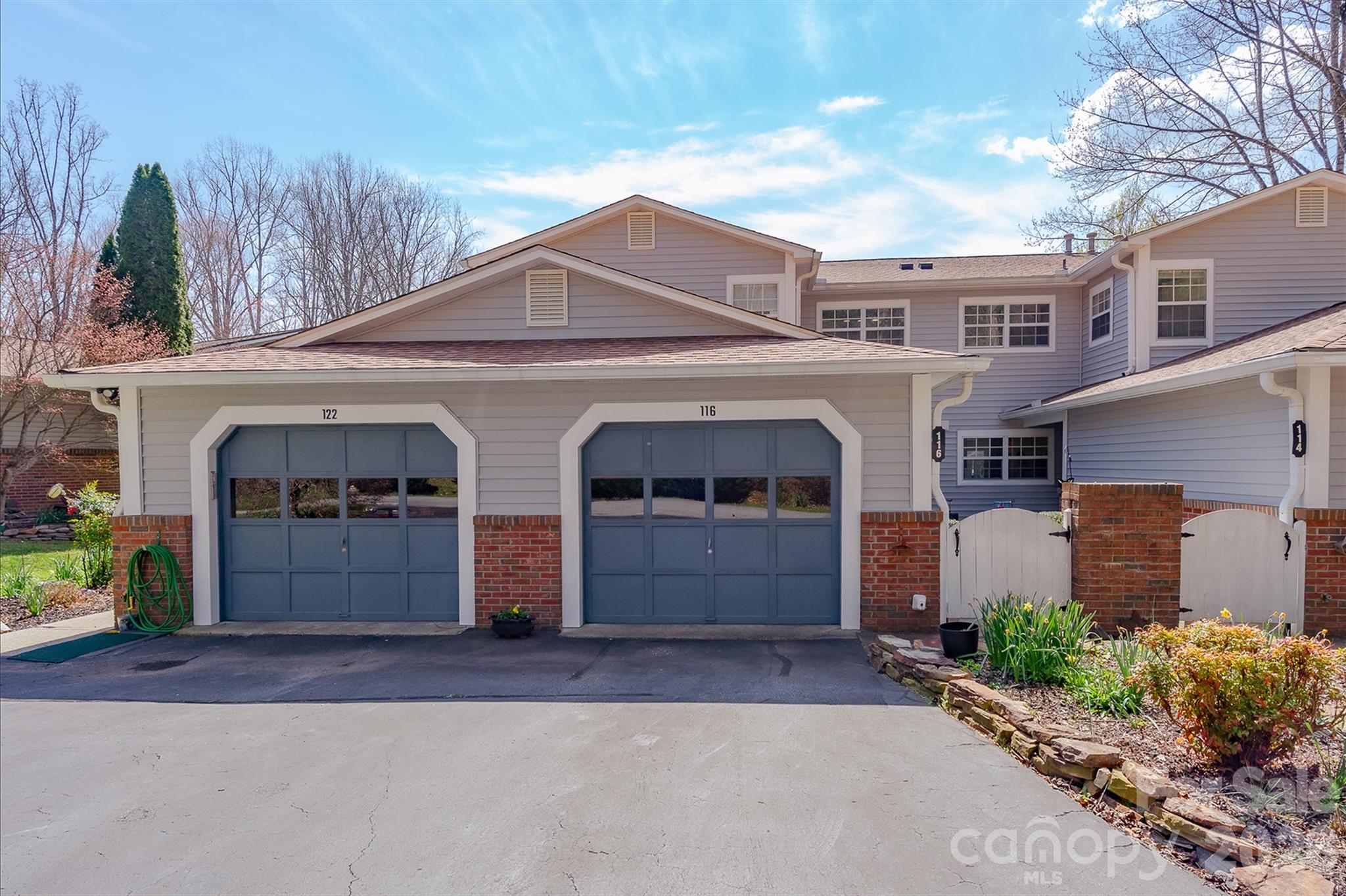 front view of a house with a yard and garage