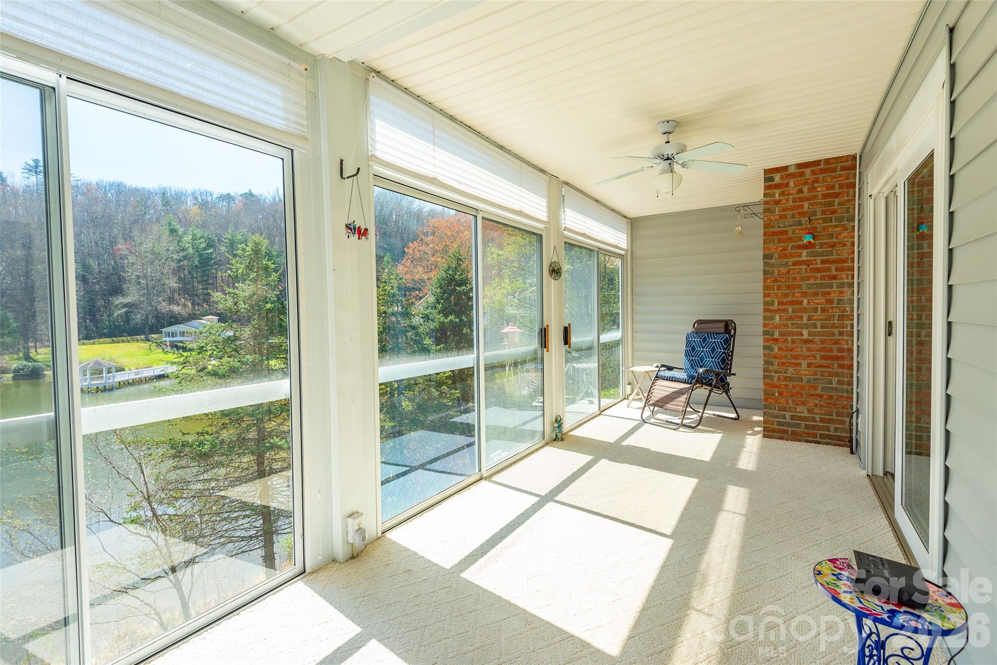 116 Lakeview Court Brevard, NC 28712 - Photo 24 of 43 a room with a balcony a bed and glass door