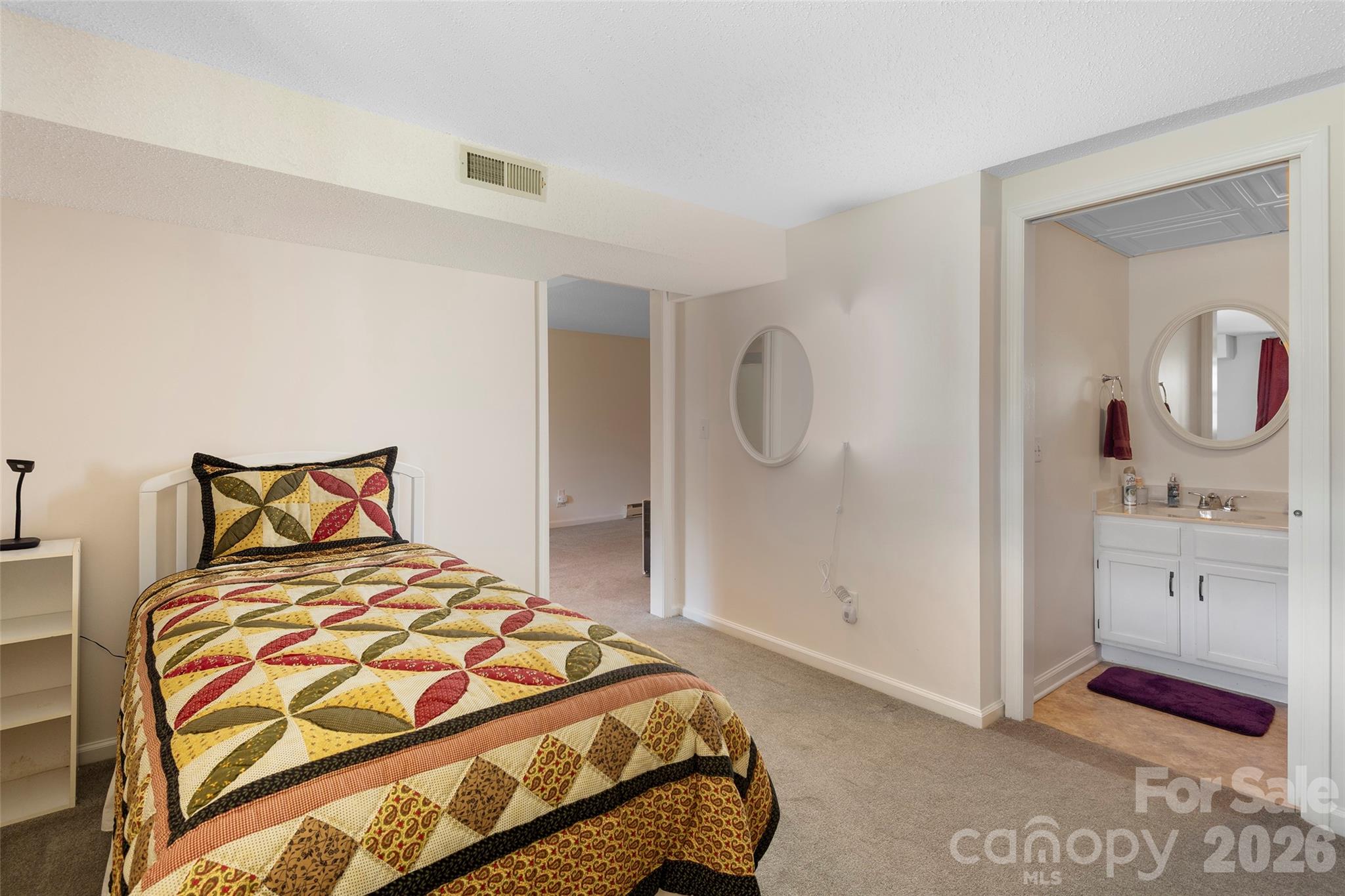 116 Lakeview Court Brevard, NC 28712 - Photo 26 of 43 a bedroom with a bed and a mirror