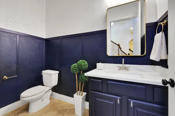 a bathroom with a toilet sink and mirror