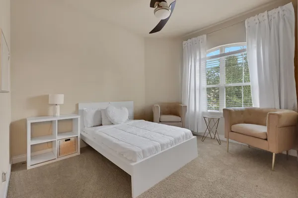 a view of room with window and ceiling fan