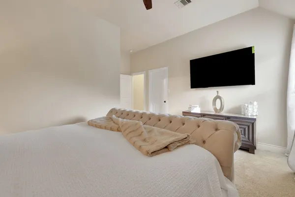 a bedroom with a bed and a mirror