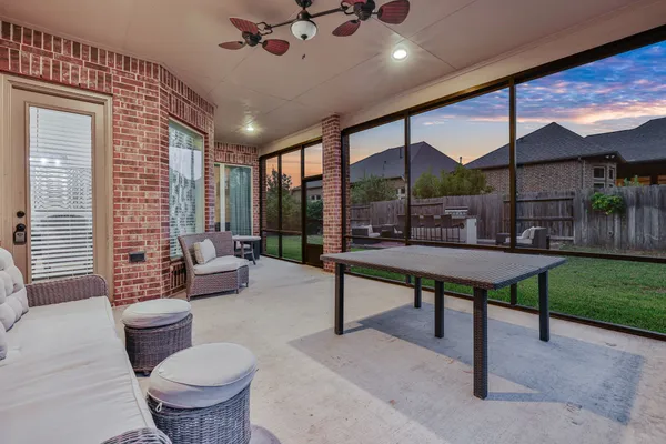 a view of a patio with table and chairs with wooden fence