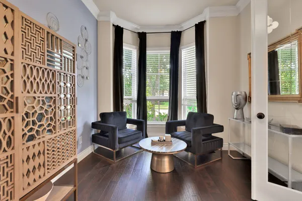 a living room with furniture and wooden floor