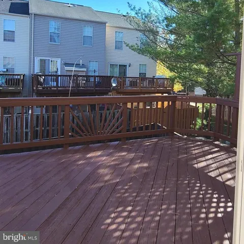 a view of a brick house with wooden fence