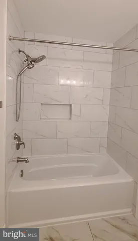 a bathroom with a shower and a bath tub