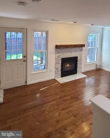 a view of a livingroom with a fireplace and window