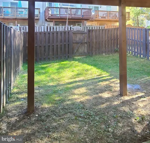 a view of a backyard with wooden fence