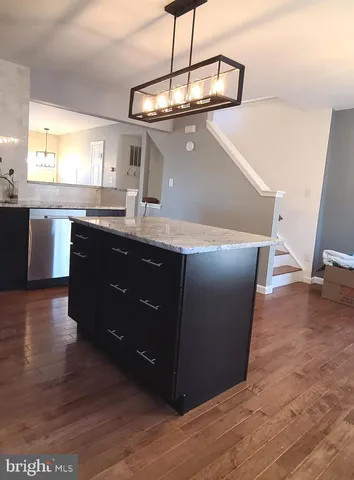 a kitchen with a sink a counter space and a window