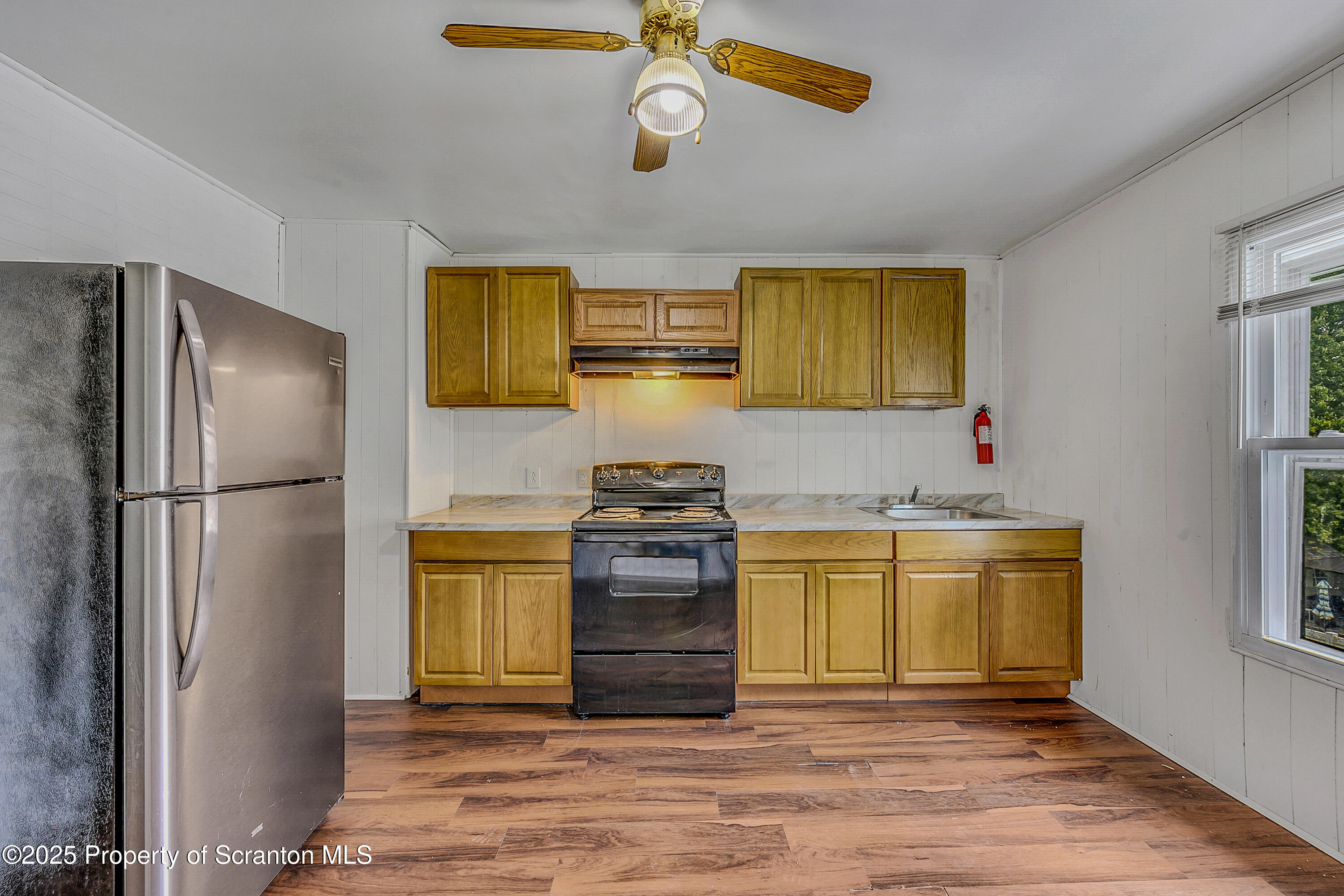 2528 Boulevard Avenue, Unit 2 Scranton, PA 18509 - Photo 3 of 18 a kitchen with stainless steel appliances granite countertop a refrigerator a stove and a wooden floors