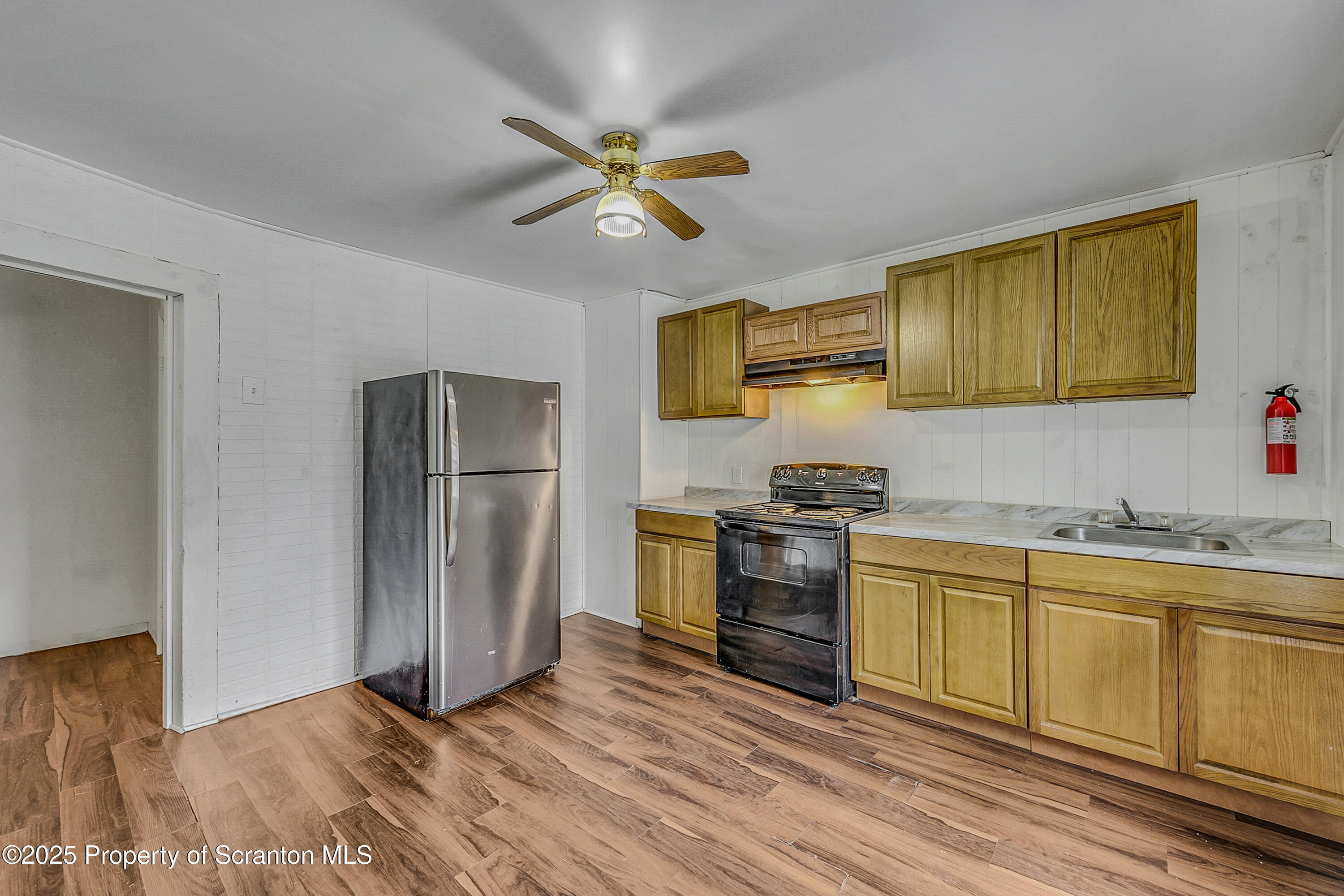2528 Boulevard Avenue, Unit 2 Scranton, PA 18509 - Photo 4 of 18 a kitchen with stainless steel appliances granite countertop a sink a stove a refrigerator cabinets and wooden floor