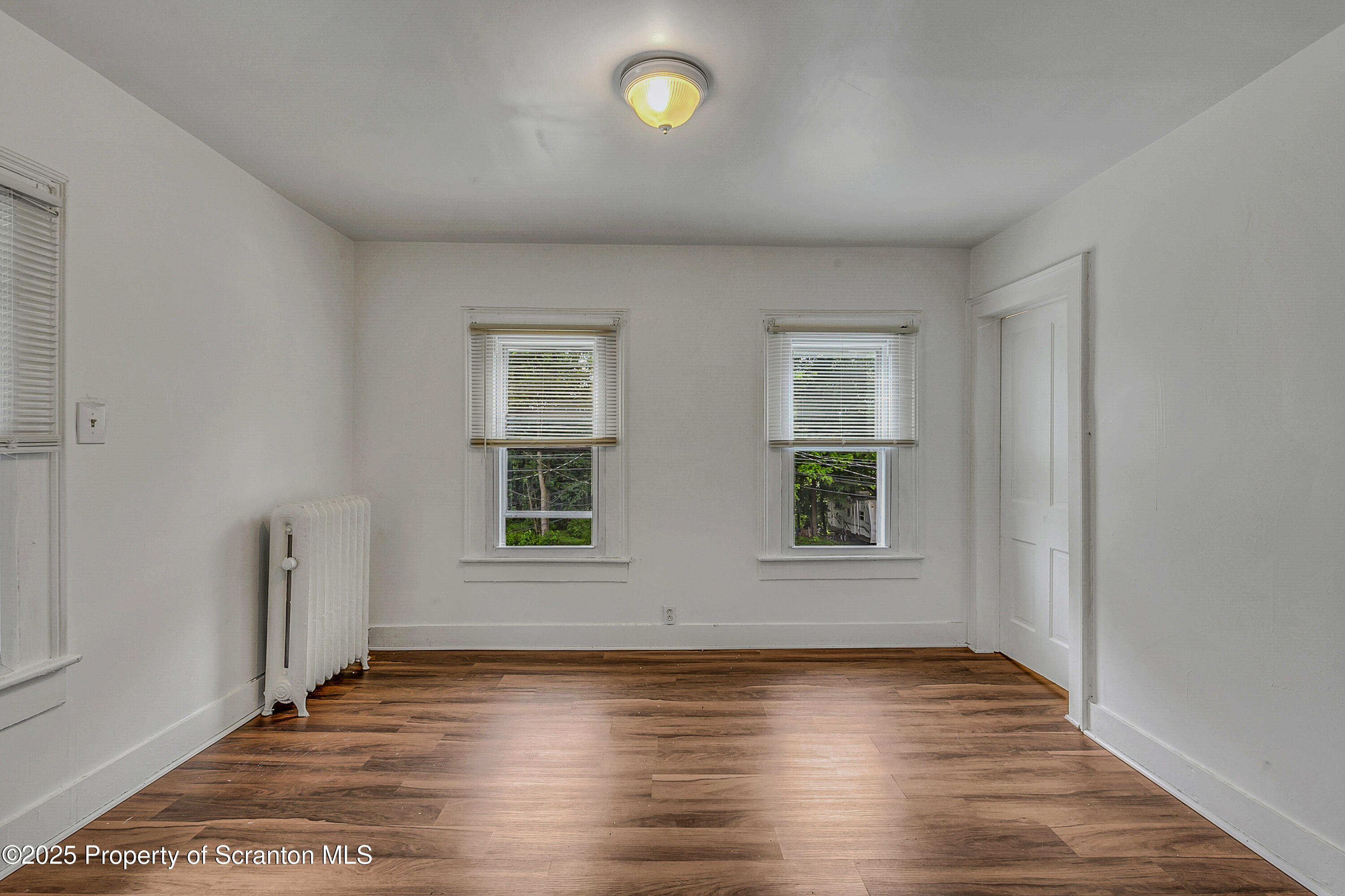 2528 Boulevard Avenue, Unit 2 Scranton, PA 18509 - Photo 5 of 18 an empty room with wooden floor and windows