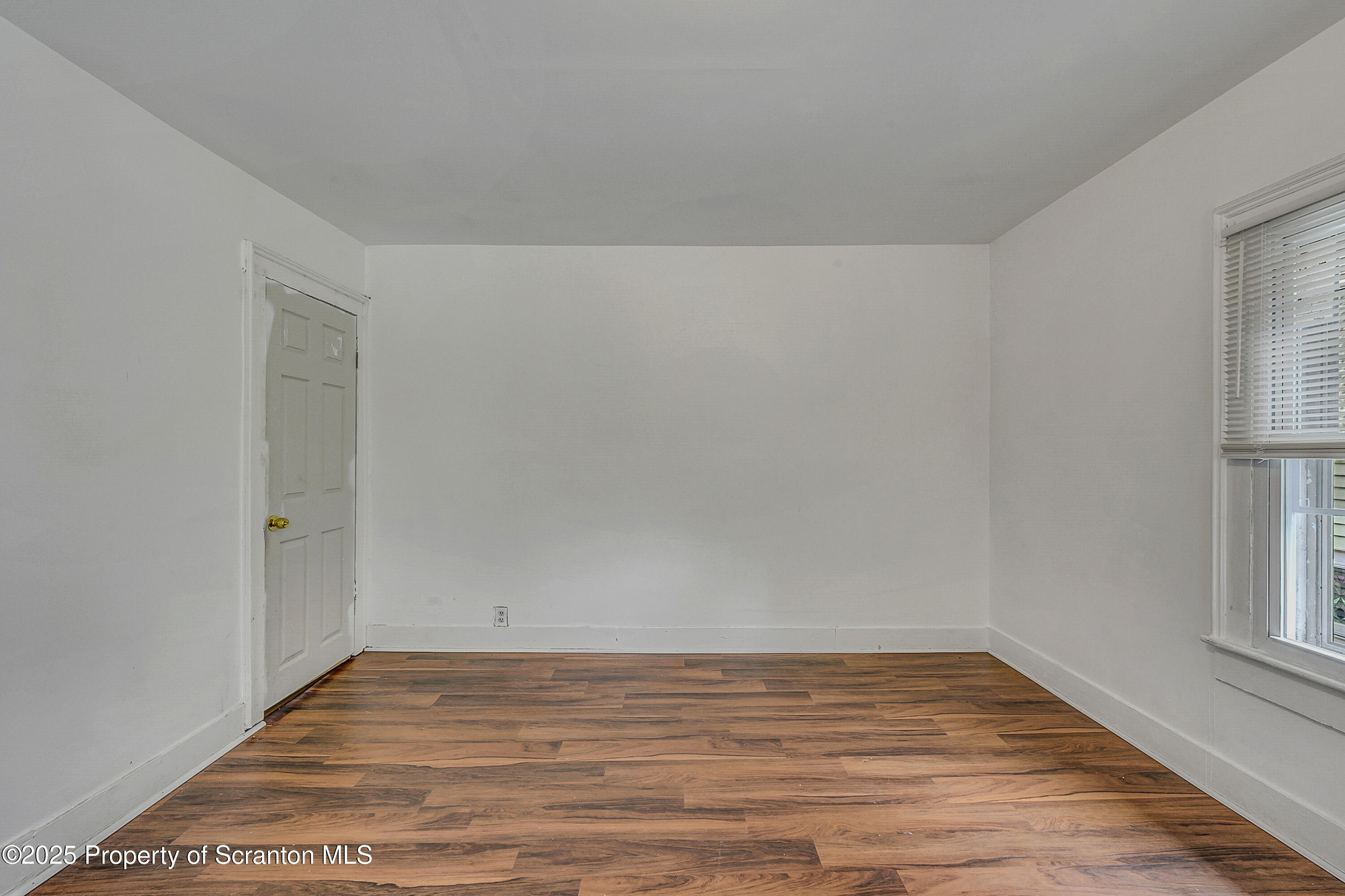 2528 Boulevard Avenue, Unit 2 Scranton, PA 18509 - Photo 8 of 18 a view of an empty room with wooden floor and a window