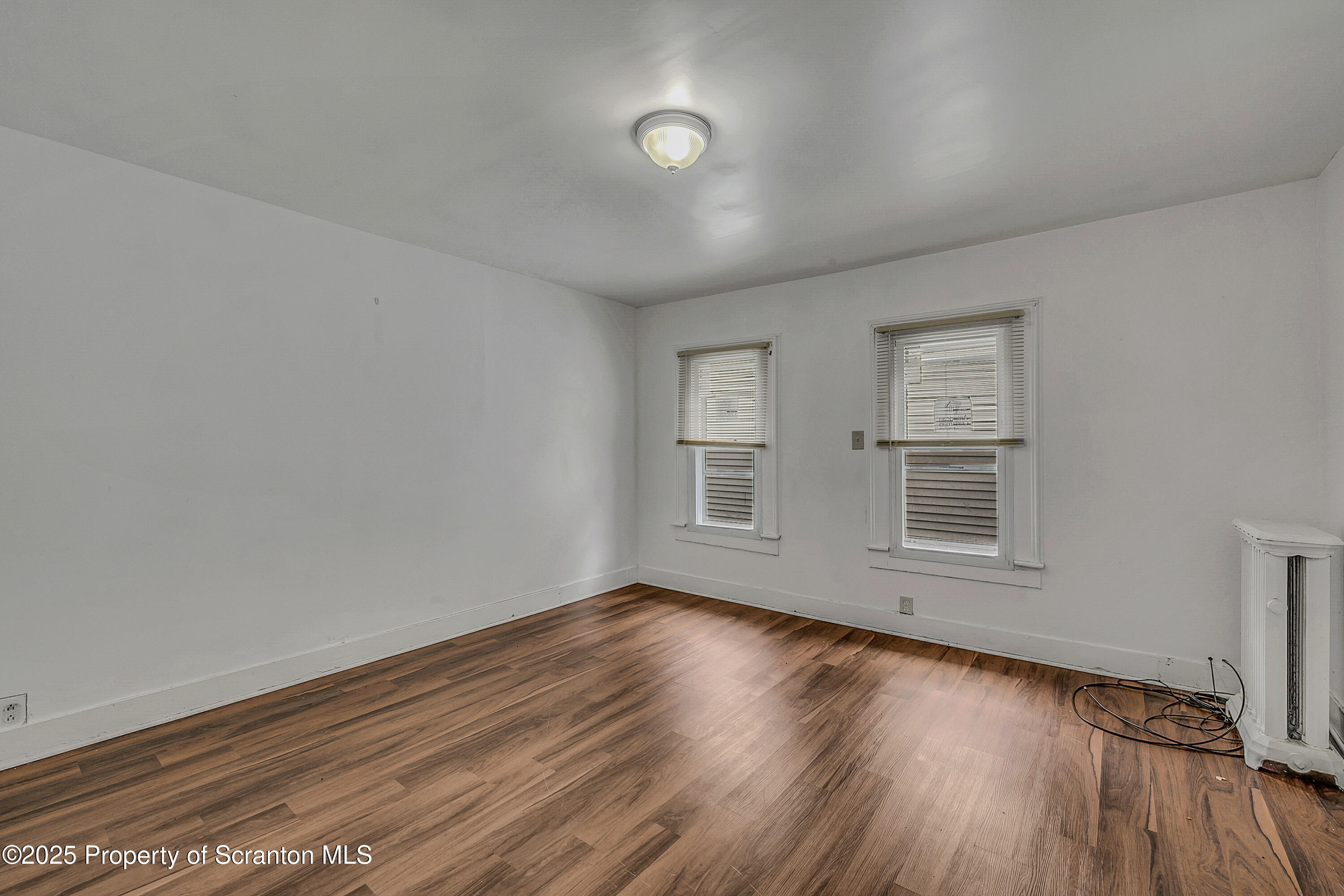 2528 Boulevard Avenue, Unit 2 Scranton, PA 18509 - Photo 10 of 18 an empty room with wooden floor and windows
