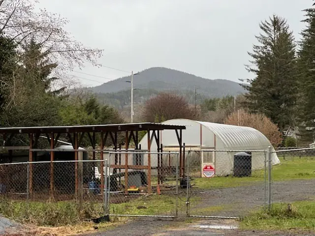a view of a white house with a ocean view