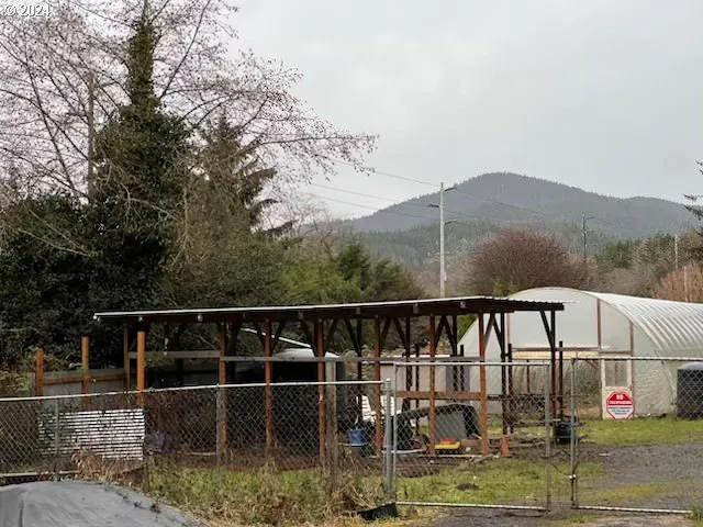 a view of a balcony with mountain view and wooden floor