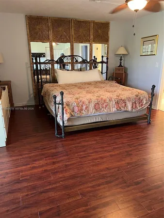 a bedroom with a bed and large window