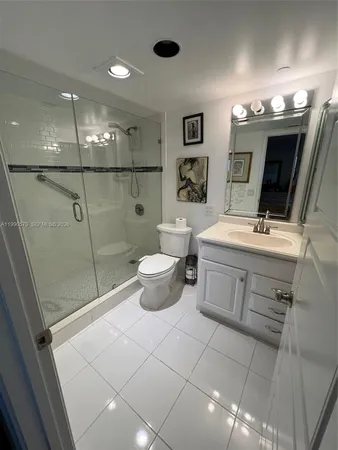 a bathroom with a sink mirror and toilet