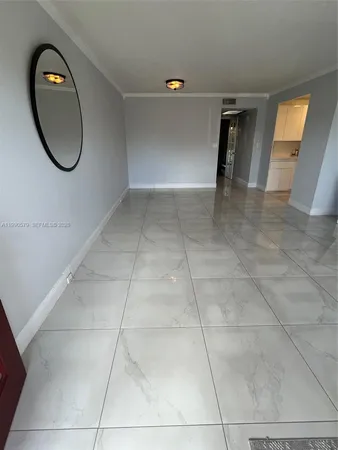 a view of a room with wooden floor and white walls