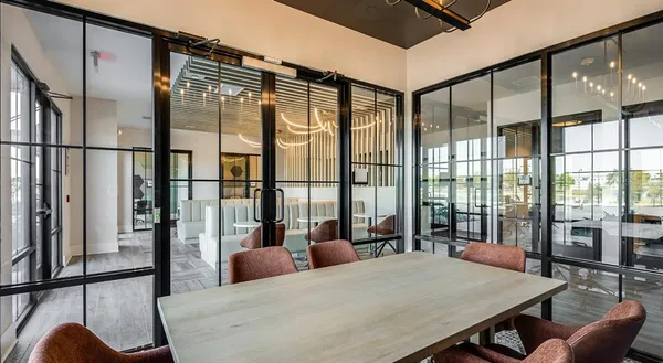 a bedroom with a bed and glass door