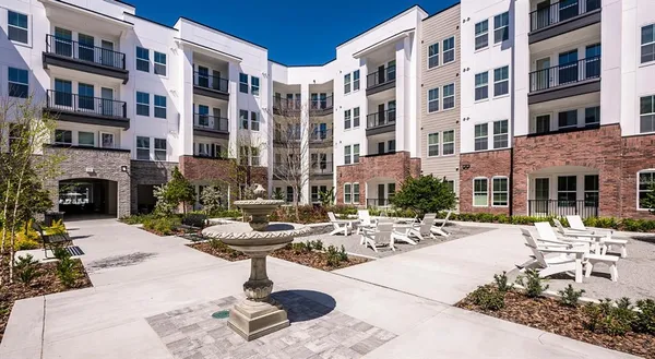 a view of a building with sitting area and furniture
