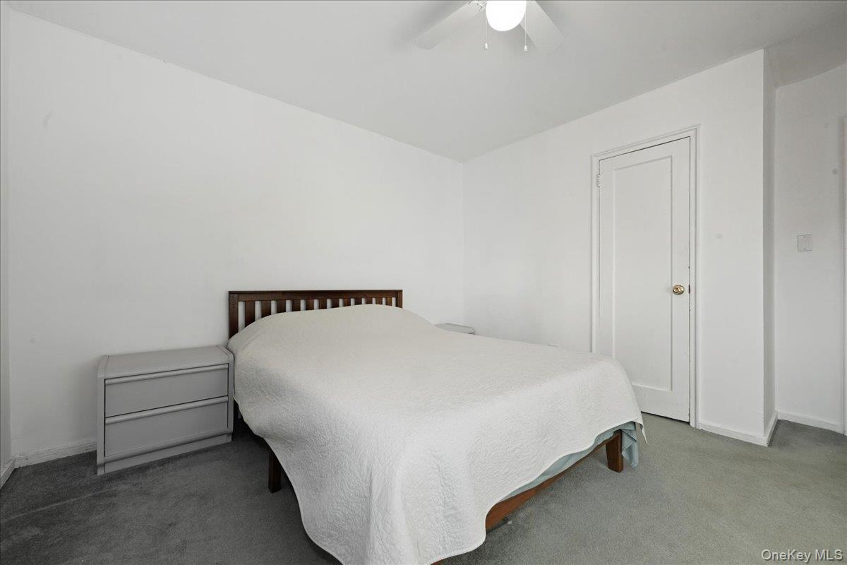 218-03 68th Avenue, Unit 1 Queens, NY 11364 - Photo 11 of 13 Bedroom featuring a ceiling fan and carpet