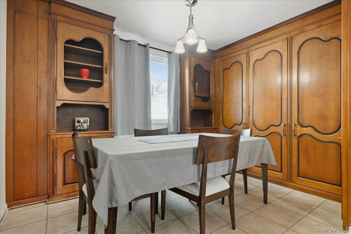 218-03 68th Avenue, Unit 1 Queens, NY 11364 - Photo 6 of 13 Dining area with light tile patterned flooring