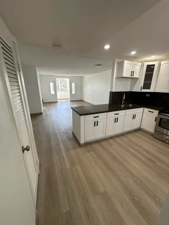a view of a living room with wooden floor