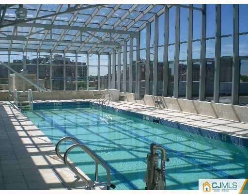 1 Spring 2402 Street, Unit 2402 New Brunswick, NJ 08901 - Photo 3 of 4 a view of swimming pool with patio