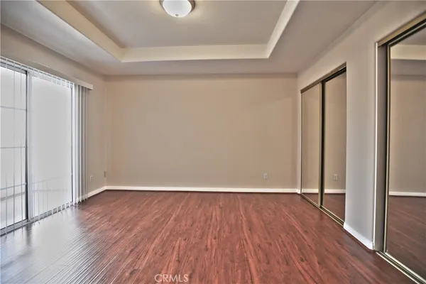 a view of a room with wooden floor