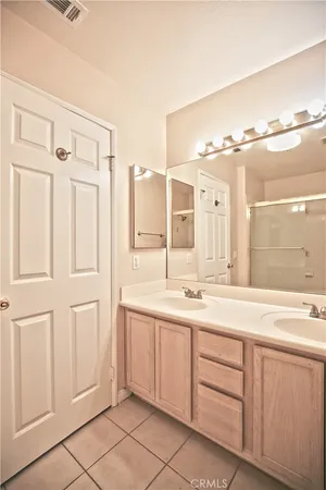 a spacious bathroom with a granite countertop sink mirror and
