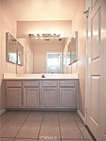 a bathroom with a granite countertop sink mirror and