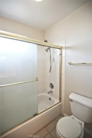 a bathroom with a shower a toilet and a shower