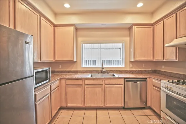 a kitchen with a sink stove and refrigerator