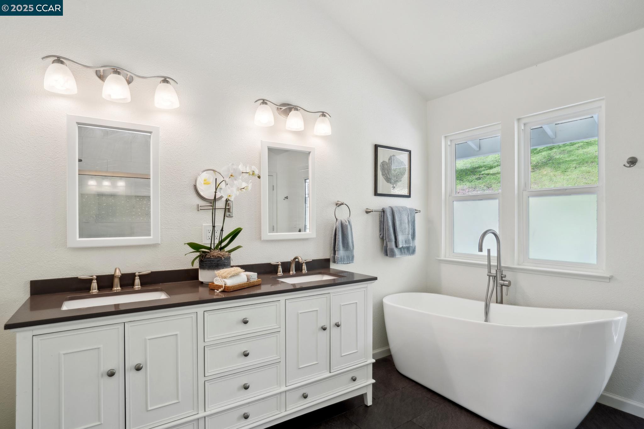 3555 Old Mountain View Drive Lafayette, CA 94549 - Photo 23 of 41 a bathroom with a double vanity sink a two mirror a window and a bathtub