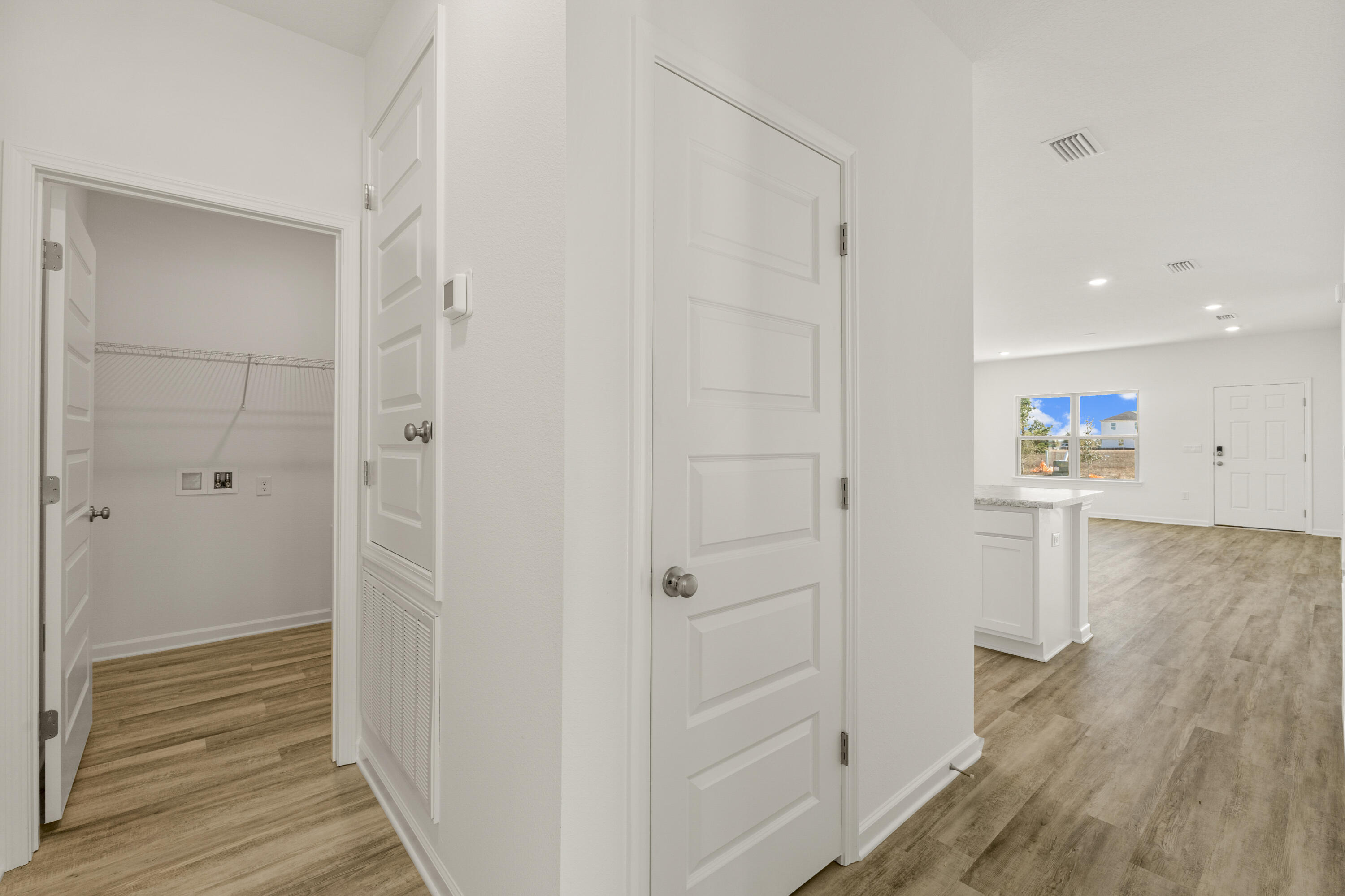 123 Staggerbush Street Freeport, FL 32439 - Photo 14 of 24 a view of a hallway with wooden floor