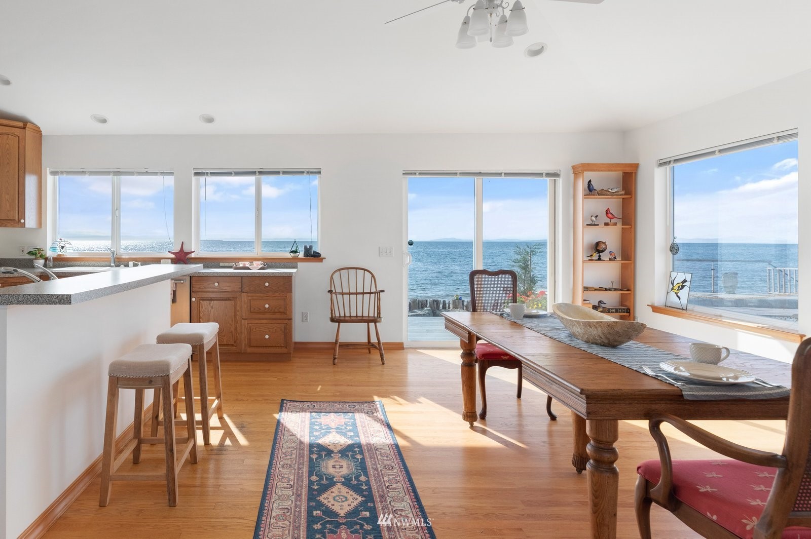 2585 West Beach Road Oak Harbor, WA 98277 - Photo 12 of 38 a open dining room with furniture a window and a kitchen view