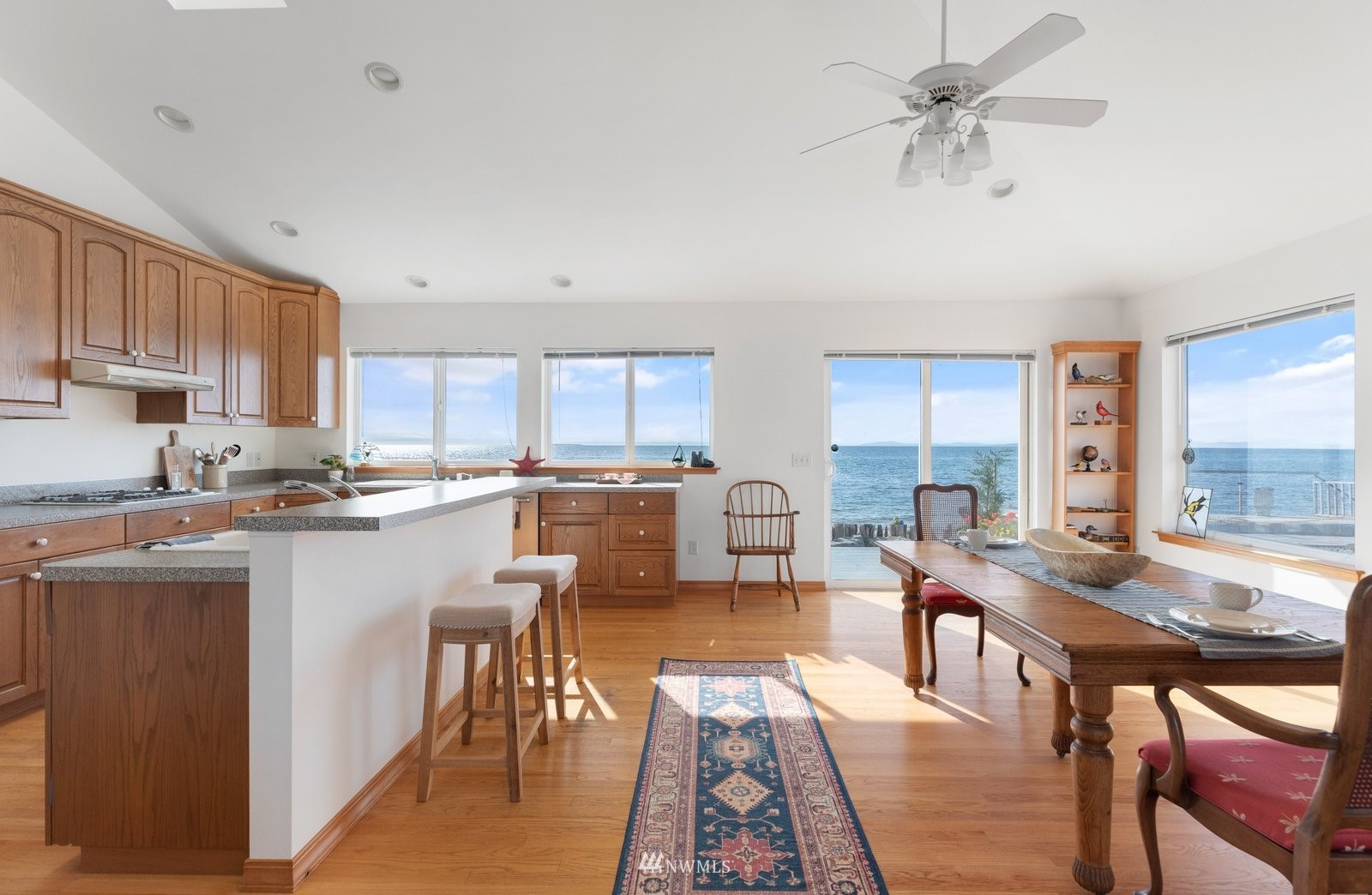 2585 West Beach Road Oak Harbor, WA 98277 - Photo 13 of 38 a kitchen with a table chairs microwave and cabinets