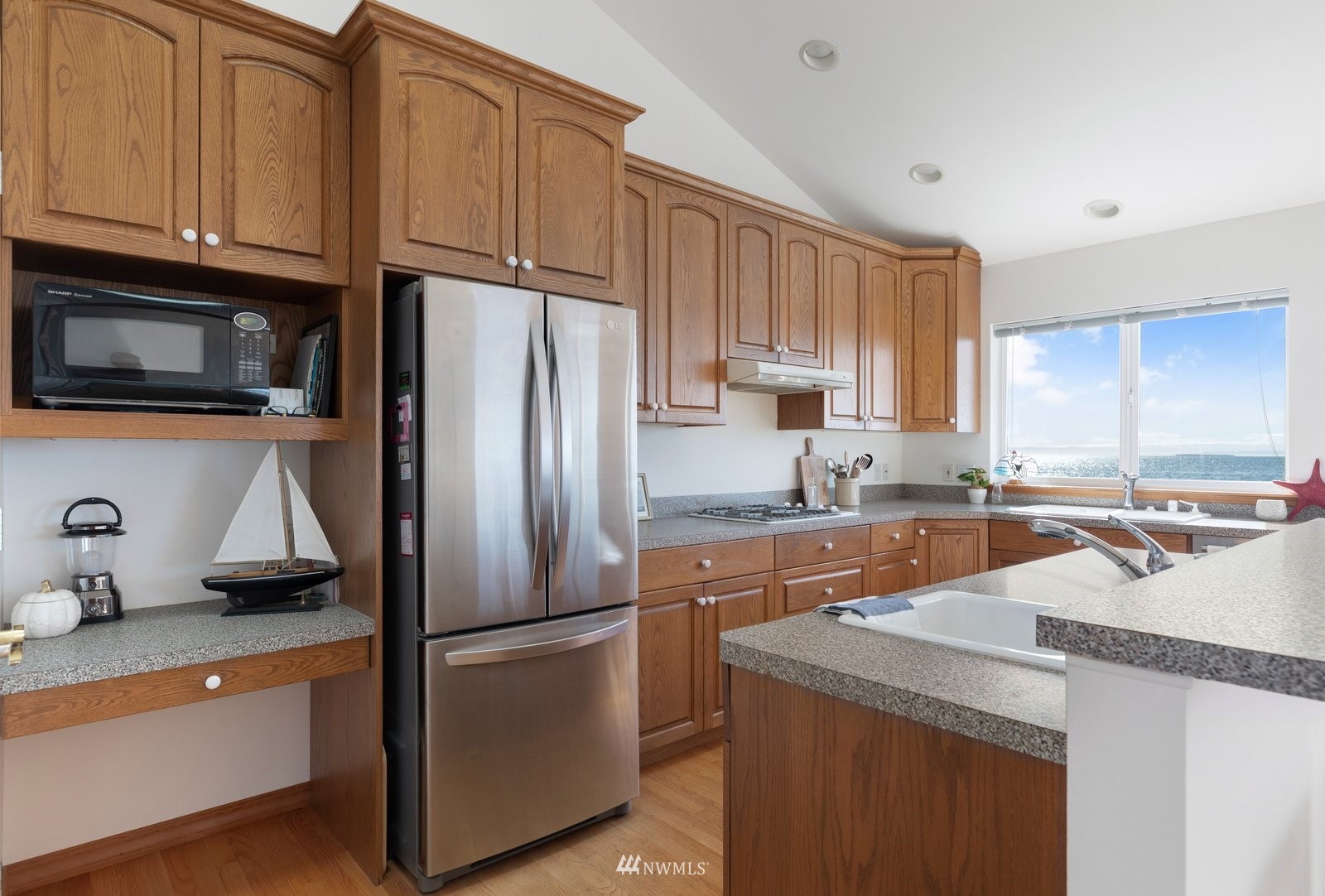 2585 West Beach Road Oak Harbor, WA 98277 - Photo 15 of 38 a kitchen with stainless steel appliances granite countertop a refrigerator stove microwave and sink