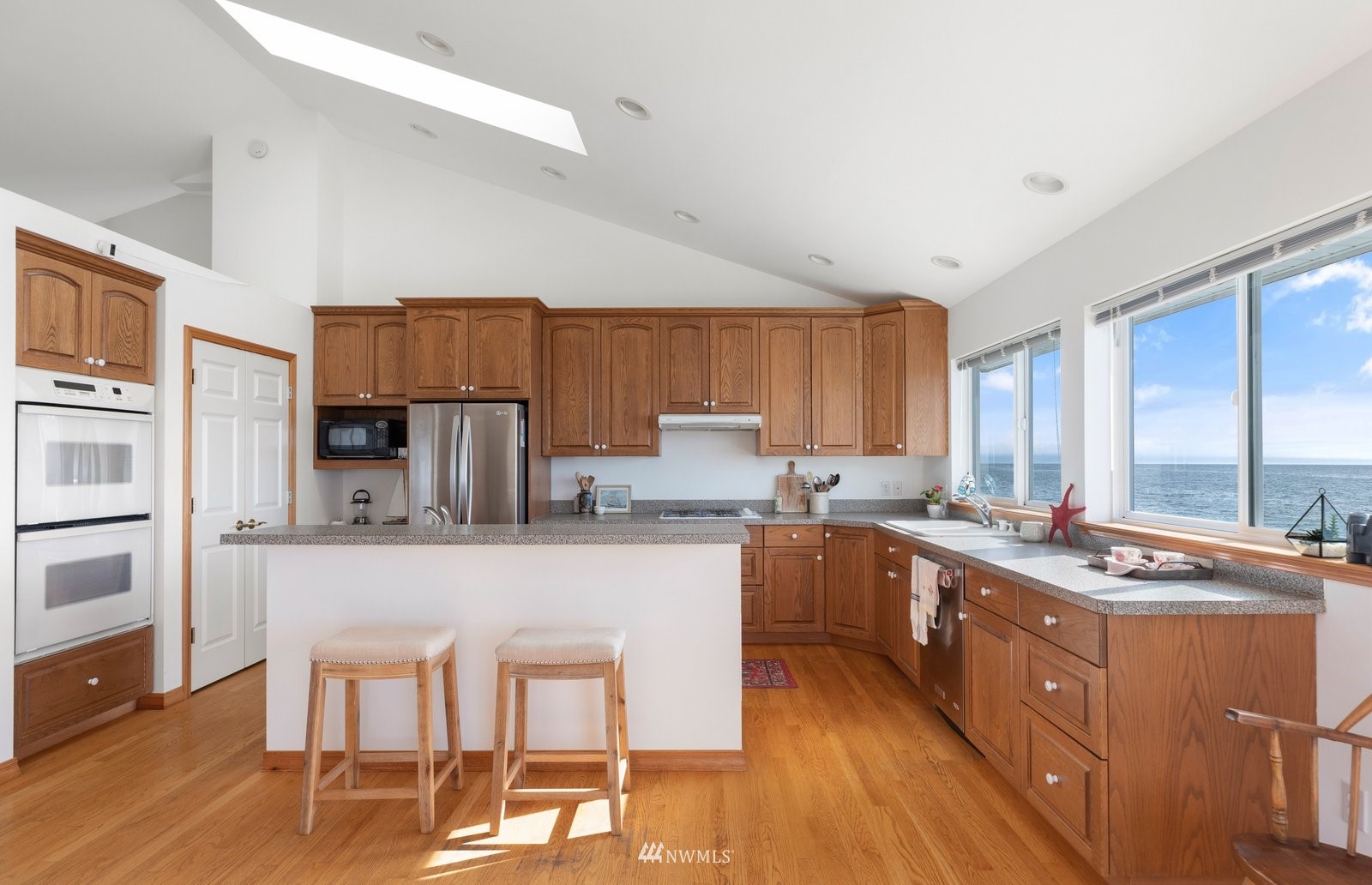 2585 West Beach Road Oak Harbor, WA 98277 - Photo 16 of 38 a kitchen with a stove a sink and a refrigerator