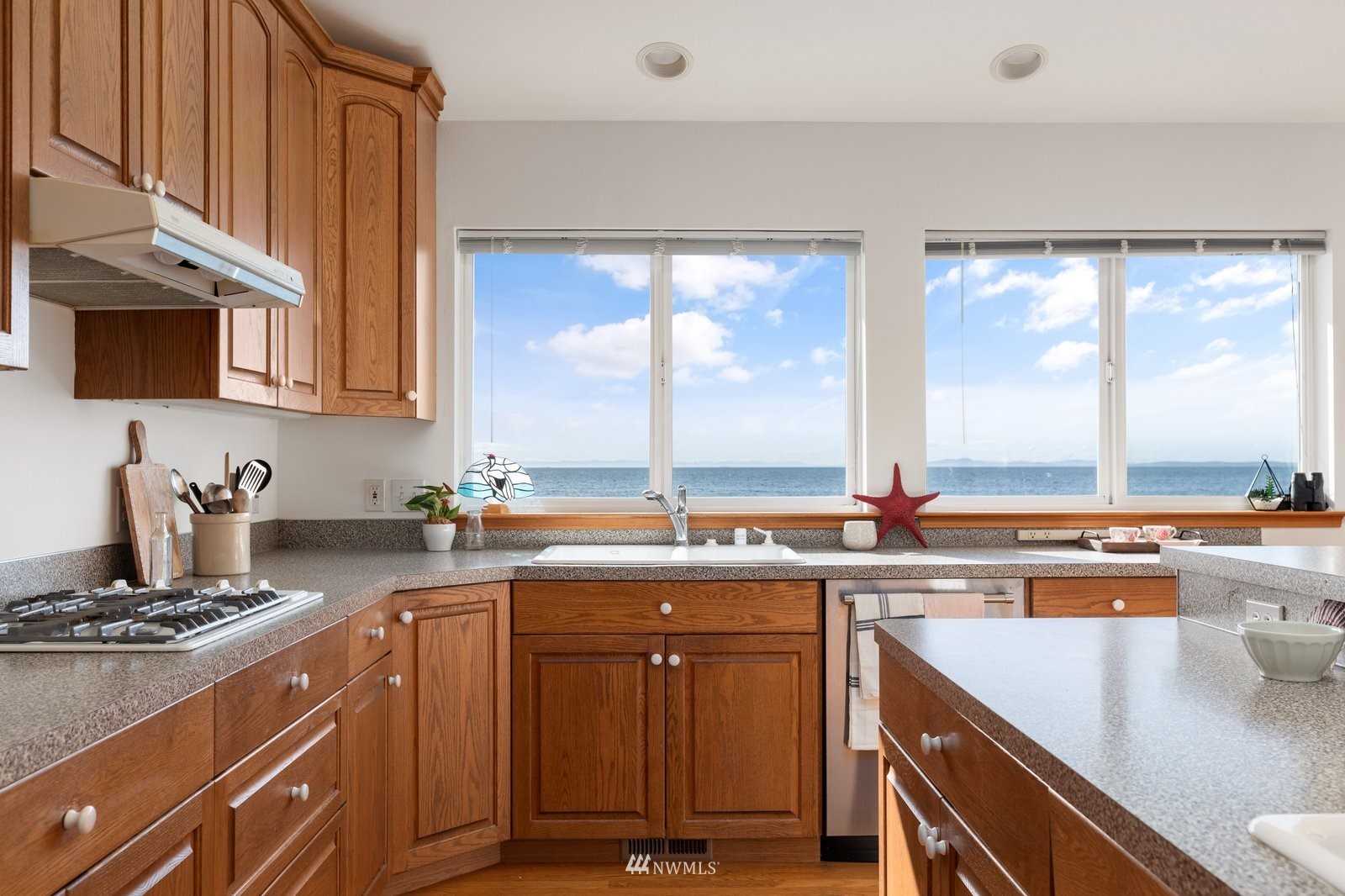2585 West Beach Road Oak Harbor, WA 98277 - Photo 17 of 38 a kitchen with a sink stove top oven and cabinets