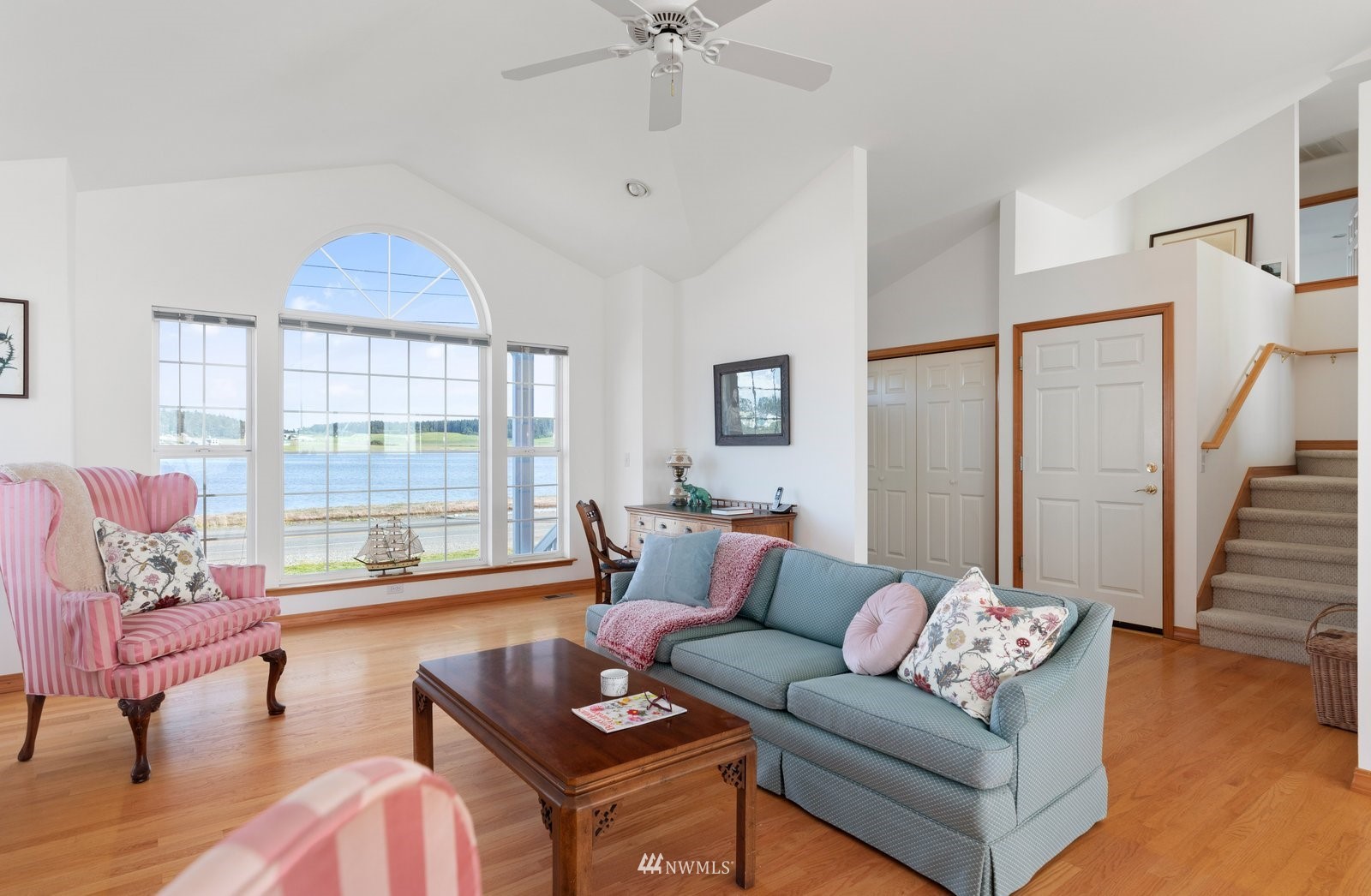 2585 West Beach Road Oak Harbor, WA 98277 - Photo 22 of 38 a living room with furniture and a large window with wooden floor
