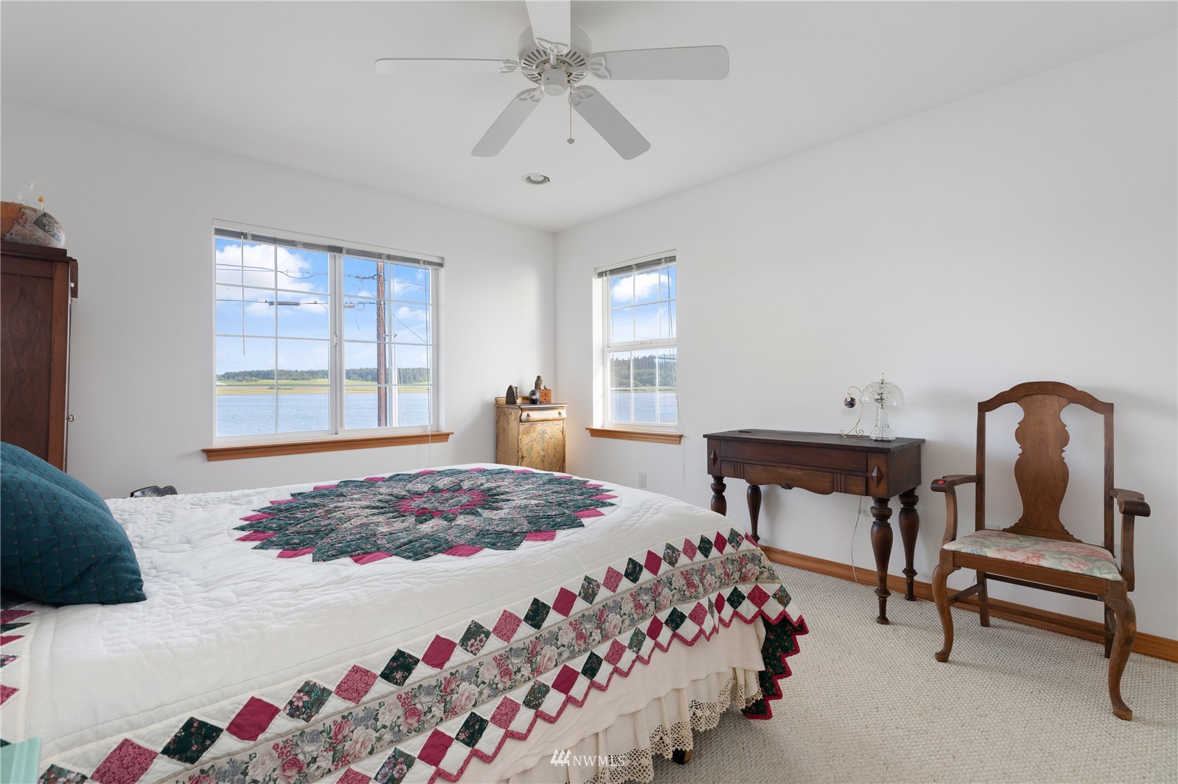 2585 West Beach Road Oak Harbor, WA 98277 - Photo 31 of 38 a bedroom with a bed and a chandelier