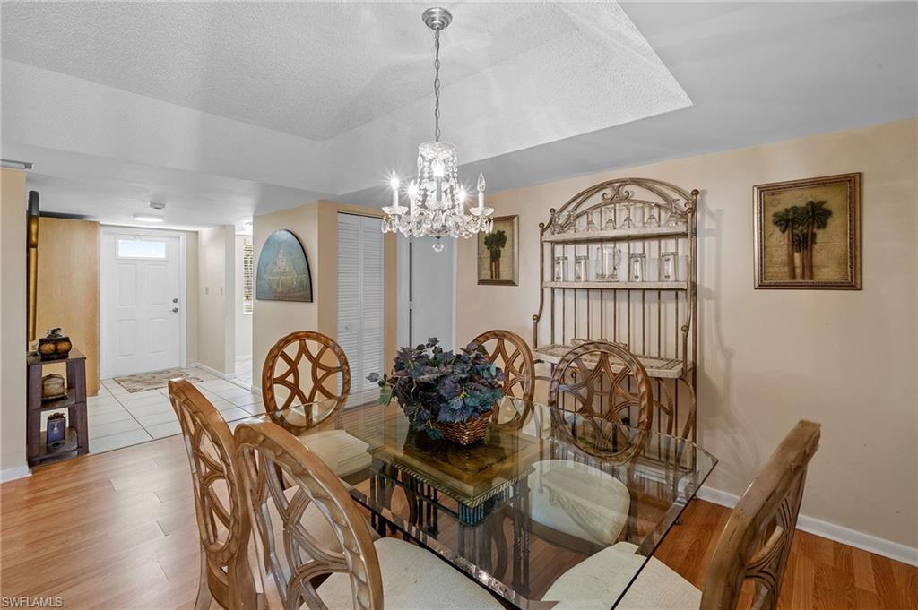817 Teryl Road, Unit 1 Naples, FL 34112 - Photo 13 of 47 a view of a dining room with furniture and chandelier