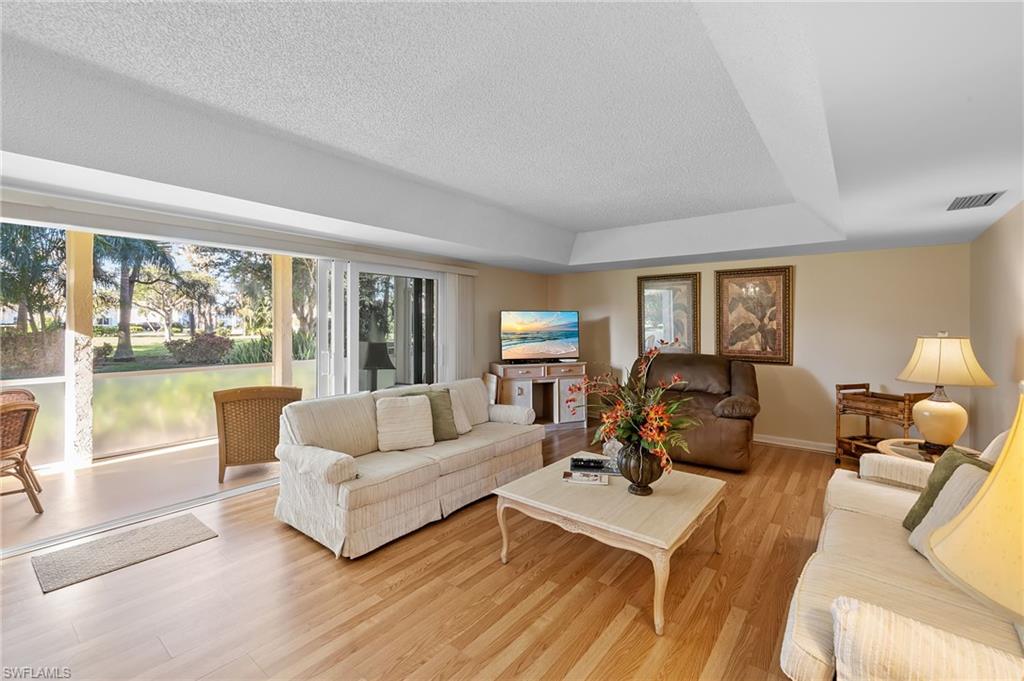 817 Teryl Road, Unit 1 Naples, FL 34112 - Photo 16 of 47 a living room with furniture and a large window